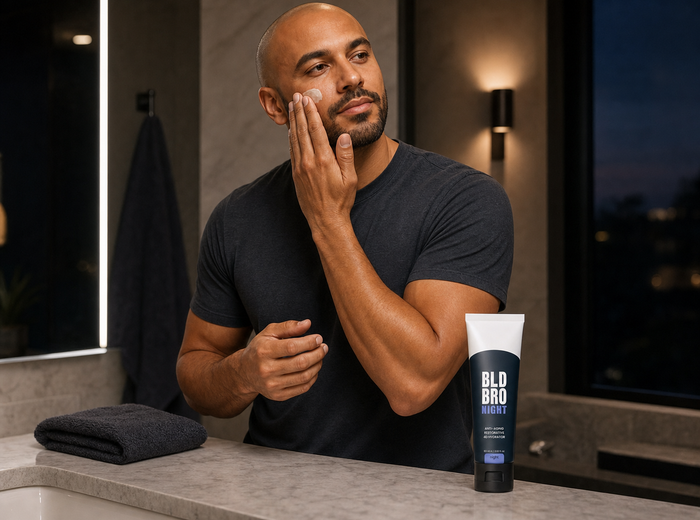 Bald man applying BLD Bro Night in an evening bathroom routine
